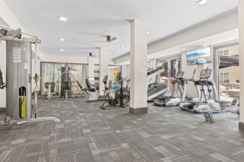 A gym with a variety of exercise equipment and a treadmill