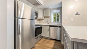 St. Louis apartment for rent - a kitchen with stainless steel appliances and white cabinets at Park 44 Apartments in St. Louis, MO, 63108