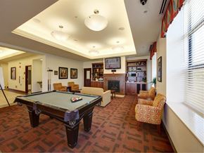Waukegan apartment for rent - a game room with a pool table and chairs