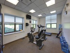 Waukegan apartment for rent - the gym has plenty of exercise equipment and windows
