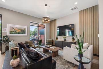 Glen Ellyn apartment for rent - A living room with a black couch and a white chair.