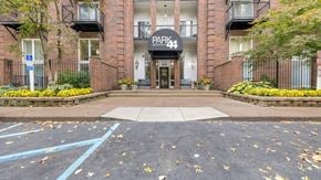 St. Louis apartment for rent - the entrance to a brick building with a parking lot in front of it at Park 44 Apartments in St. Louis, MO, 63108
