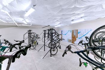 A room filled with bikes and paintings on the wall