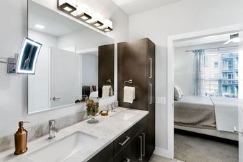 A bathroom with a large mirror and a sink