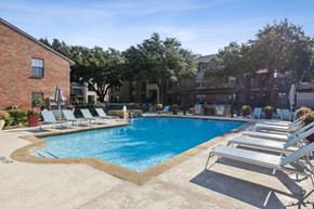 Plano apartment for rent - our apartments have a large swimming pool and lounge chairs at Wellington at Willow Bend Apartments, Texas