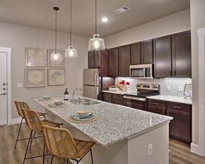 Denton apartment for rent - a kitchen with a marble counter top at Hunters Creek Apartments, Denton, 76210