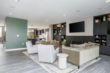 Westmont apartment for rent - A modern living room with a grey sofa and a white armchair.