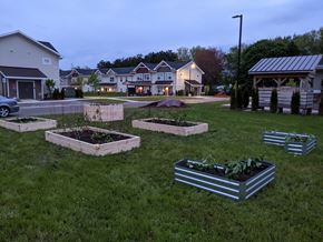 Portage apartment for rent - A garden with raised beds in the foreground and houses in the background.