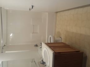 Kalamazoo apartment for rent - A white bathroom with a white tub and a white sink.