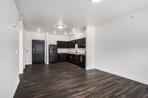 Portage apartment for rent - A kitchen area with dark wood floors and white walls.