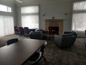 Kalamazoo apartment for rent - A conference room with a fireplace and chairs.