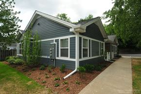 Kalamazoo apartment for rent - A small house with a grey siding and white trim.