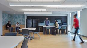 Detroit apartment for rent - A group of people are gathered in a modern office space.