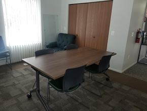 Kalamazoo apartment for rent - A conference room with a table, chairs, and a couch.