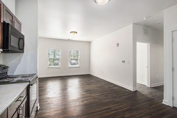 Portage apartment for rent - A kitchen with a microwave on the wall and a wooden floor.