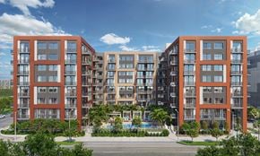 Miami apartment for rent - A modern apartment complex with red and beige buildings and a pool in the courtyard.