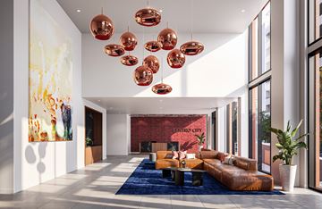 Miami apartment for rent - A modern living room with a blue rug and orange couch.
