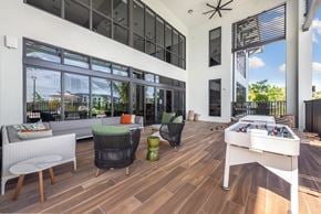 Miami apartment for rent - a patio with a foosball table and chairs