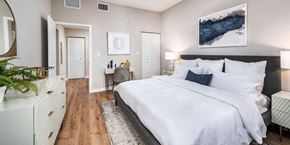 Pembroke Pines apartment for rent - a bedroom with a large bed and a desk with a chair