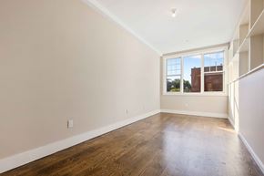 Brooklyn apartment for rent - Empty room with wooden floors and a window.