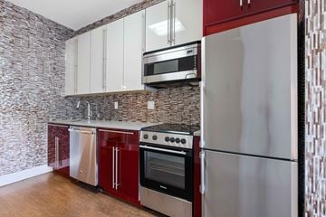 Brooklyn apartment for rent - A kitchen with a refrigerator, oven, and microwave.