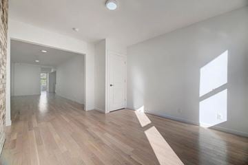 Brooklyn apartment for rent - A room with wooden floors and white walls.