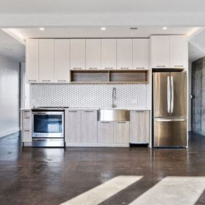 Brooklyn apartment for rent - A modern kitchen with a stainless steel refrigerator and a backsplash with a pattern of circles.