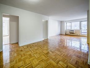 New York apartment for rent - A room with wooden flooring and white walls.