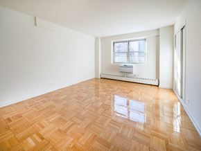 New York apartment for rent - A room with a window and a radiator on the wall.