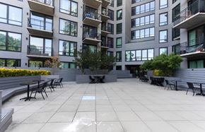 Brooklyn apartment for rent - A courtyard with a table and chairs surrounded by apartment buildings.