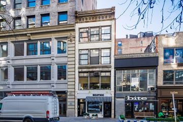 New York apartment for rent - a white van parked in front of a building on a city street
