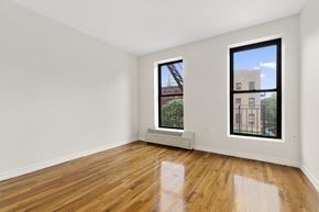 New York apartment for rent - A room with a window and a radiator on the wall.