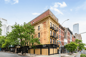 New York apartment for rent - A large brick building with a black awning on the corner of a street.