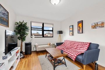 New York apartment for rent - A living room with a couch, a television, and a plant.