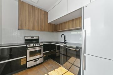 Brooklyn apartment for rent - A modern kitchen with a stove, oven, and refrigerator.