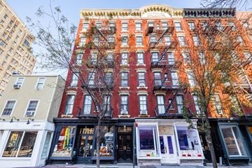 New York apartment for rent - a building on a city street with a fire escape
