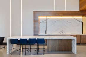 Brooklyn apartment for rent - a kitchen with a marble counter top and blue chairs at The Paxton, Brooklyn, New York