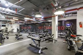 New York apartment for rent - A gym with a variety of equipment including treadmills, stationary bikes, and weight machines.