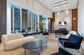 Brooklyn apartment for rent - a lounge area with couches chairs and tables and a television at The Paxton, Brooklyn, NY