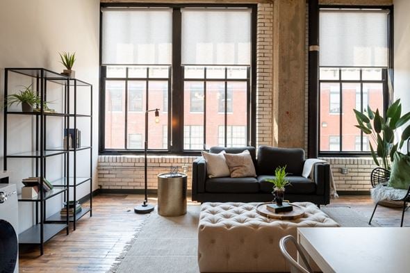 St Louis apartment for rent - a living area with a couch coffee table and large windows at The Draper, Missouri