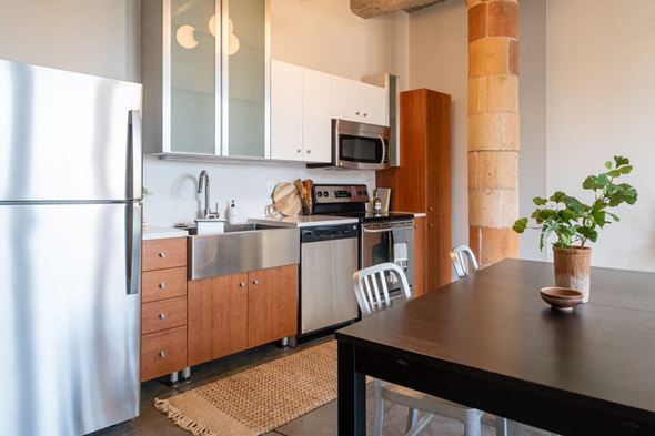 St. Louis apartment for rent - a kitchen with white cabinets and stainless steel appliances