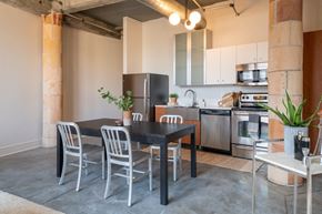 St. Louis apartment for rent - a dining area with a table and chairs and a kitchen in the background
