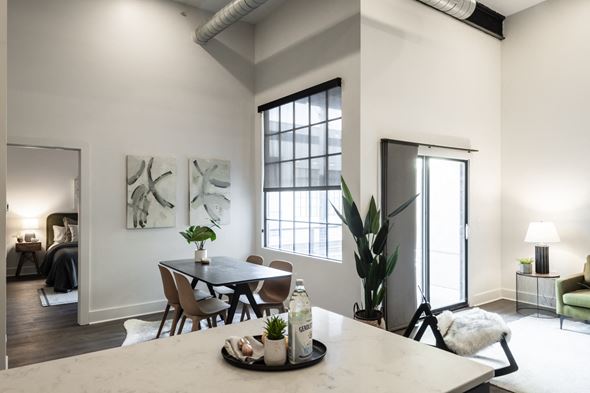 Saint Louis apartment for rent - an open living room and dining room with a large window and a table