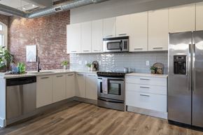 St. Louis apartment for rent - a kitchen with stainless steel appliances and white cabinets