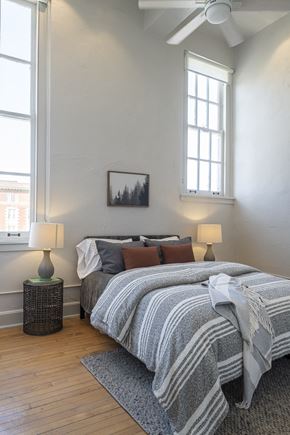 St. Louis apartment for rent - a bedroom with a bed and two windows
