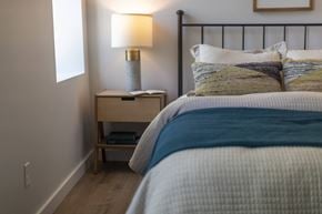 St. Louis apartment for rent - a bedroom with a bed and a nightstand with a lamp
