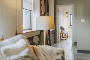 St. Louis apartment for rent - A cozy bedroom with a bed and a lamp.