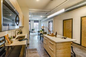 St. Louis apartment for rent - A modern kitchen with wooden cabinets and a large island.