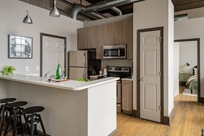 St. Louis apartment for rent - an open kitchen and living room with a bar and stools