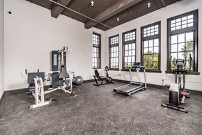 St. Louis apartment for rent - gym with exercise equipment and windows at the district flats apartments in lenexa